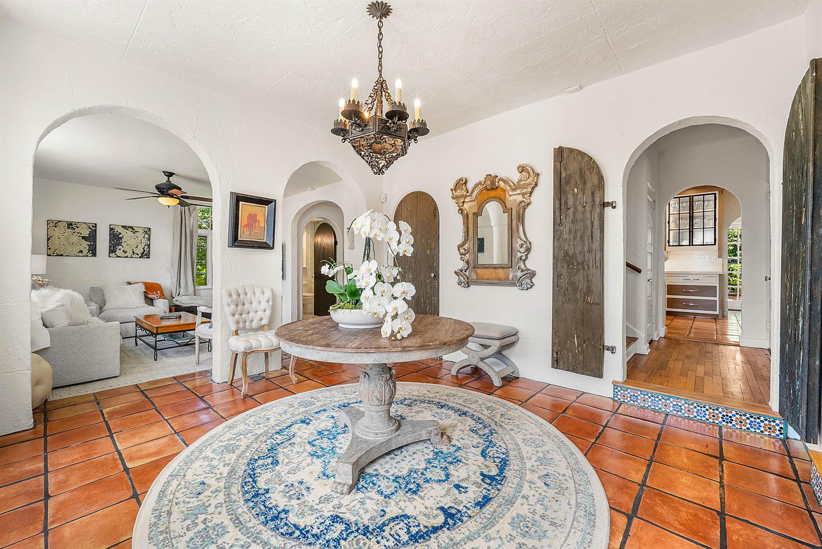 A foyer with terracotta tile floors, a round table, and arched doorways leading to other rooms — 255 Cordova Road, West Palm Beach FL 33401, WEST PALM BEACH, FL
