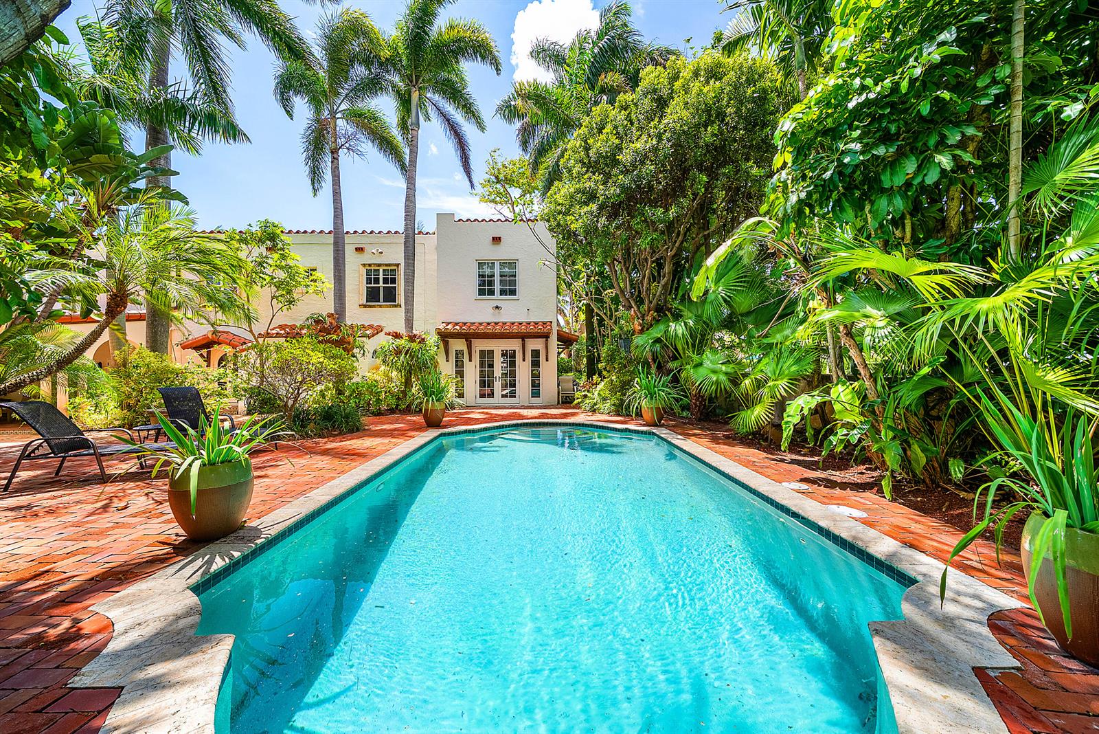 A rectangular swimming pool sits on a brick patio in front of a stucco house — 255 Cordova Road, West Palm Beach FL 33401, WEST PALM BEACH, FL