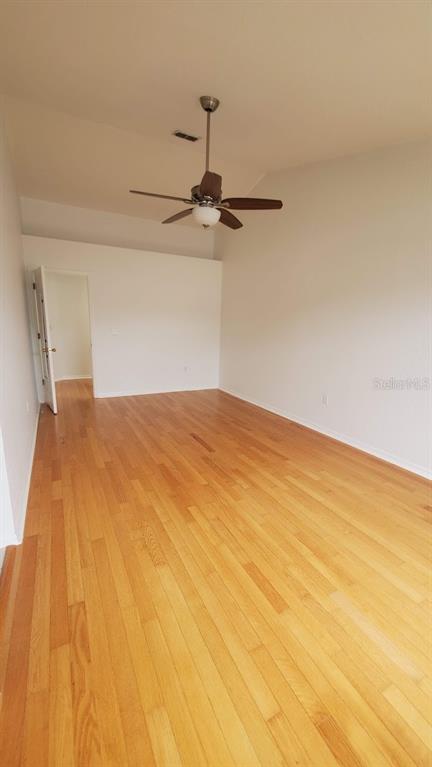 An empty room with light wood flooring, white walls, and a ceiling fan — 4176 BRENTWOOD PARK CIRCLE, TAMPA, FL