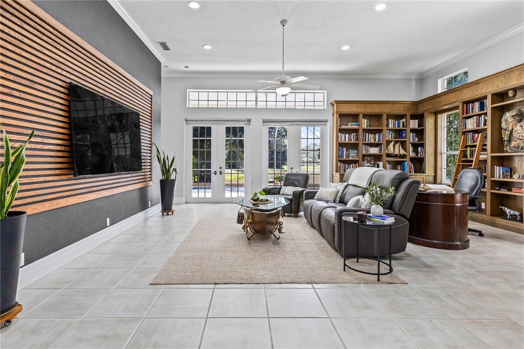 A screened-in patio features a swimming pool, outdoor furniture, and a view of a pond — 7105 VICTORIA CIRCLE, BRADENTON, FL