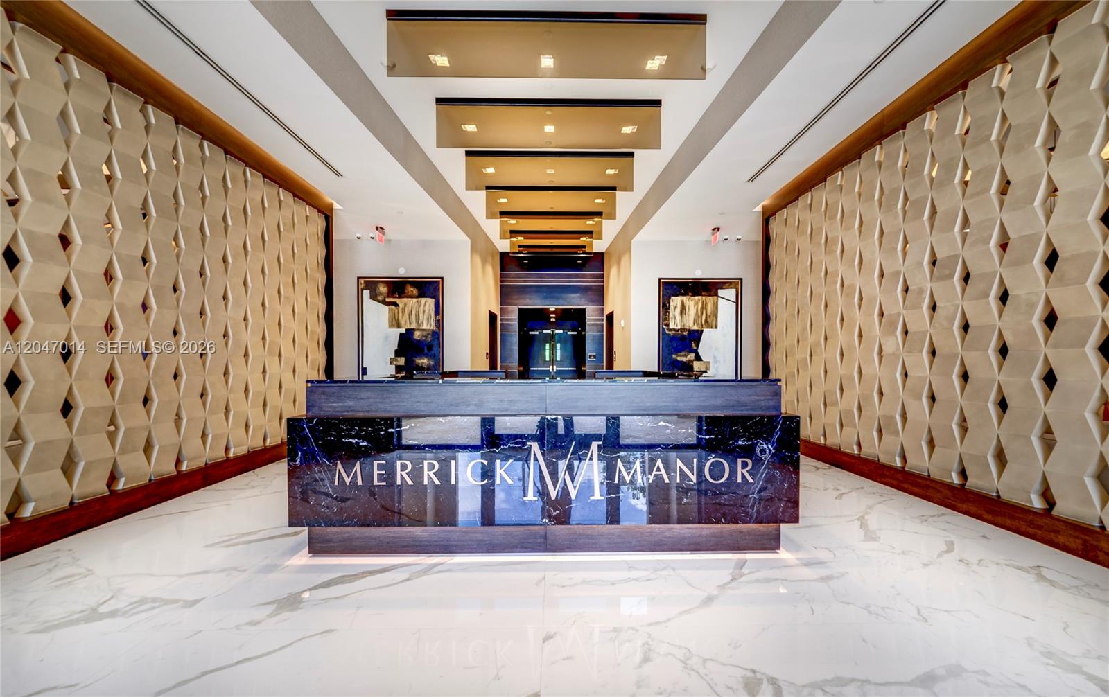 A modern lobby features a dark marble reception desk with a logo and geometric wall panels — 301 Altara Ave # 733, Coral Gables FL 33146, CORAL GABLES, FL
