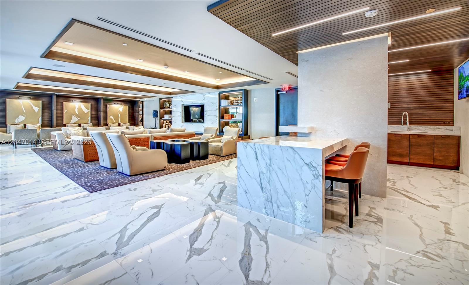 A modern lounge area features marble flooring, a marble-topped bar, and recessed ceiling lighting — 301 Altara Ave # 733, Coral Gables FL 33146, CORAL GABLES, FL