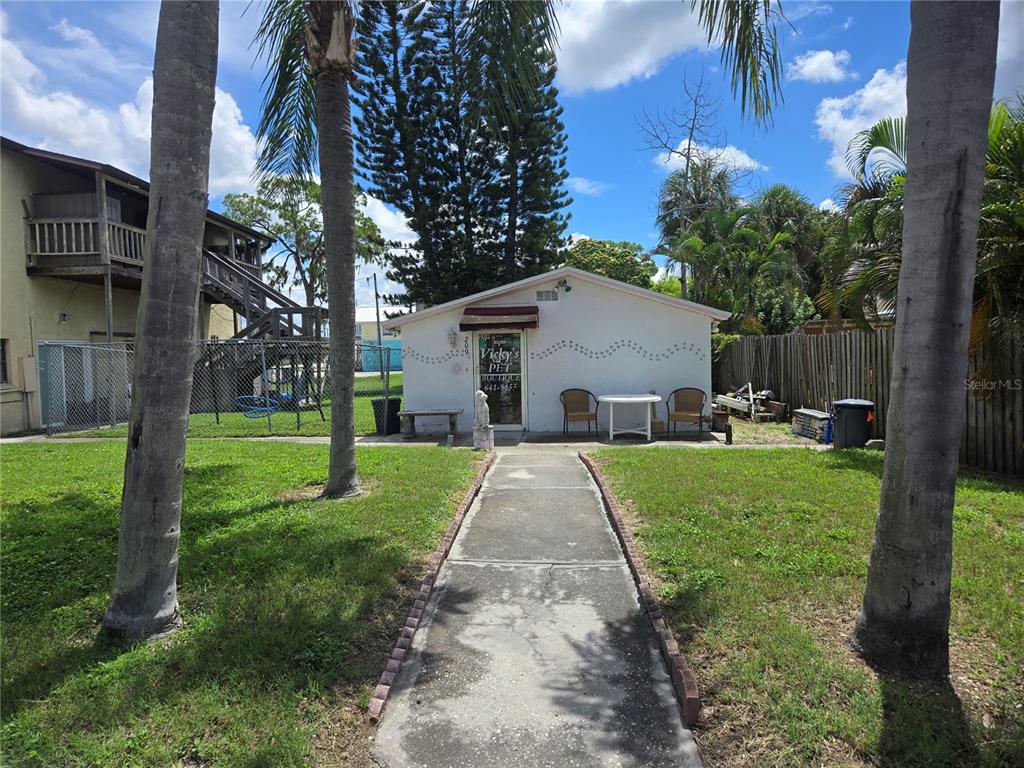 A small white building with a walkway leading to the entrance and palm trees — 110 W SHELL POINT ROAD, RUSKIN, FL