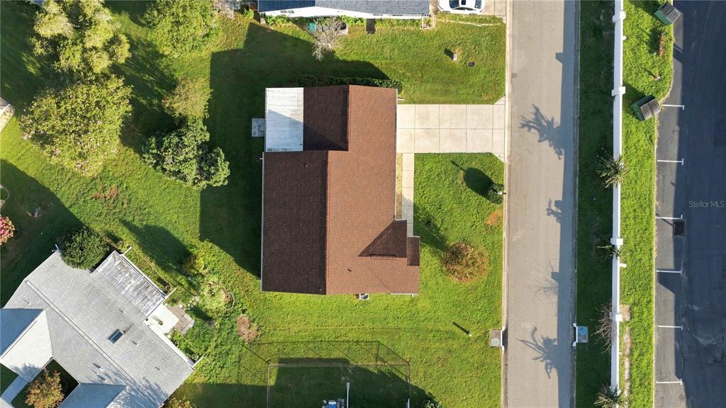 An aerial view shows a house with a brown roof, a driveway, and surrounding lawn — 17960 SE 108TH COURT, SUMMERFIELD, FL