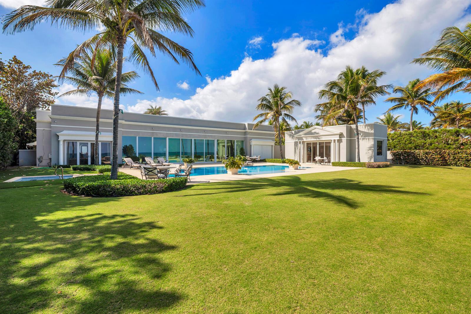 A large house with a swimming pool and palm trees sits on a grassy lawn — 5 Via Los Incas, Palm Beach FL 33480, PALM BEACH, FL