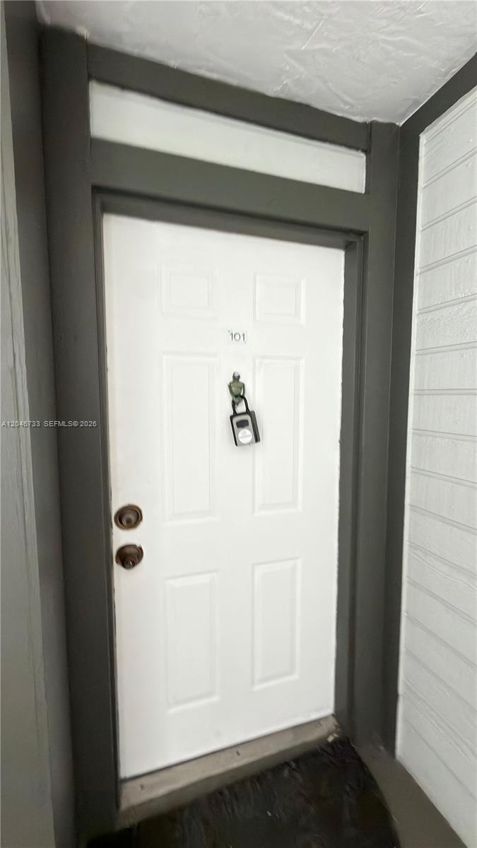 A white front door with a lockbox and the number 101 is set in a frame — 469 NE 207th Ln # 101, Miami FL 33179, MIAMI, FL