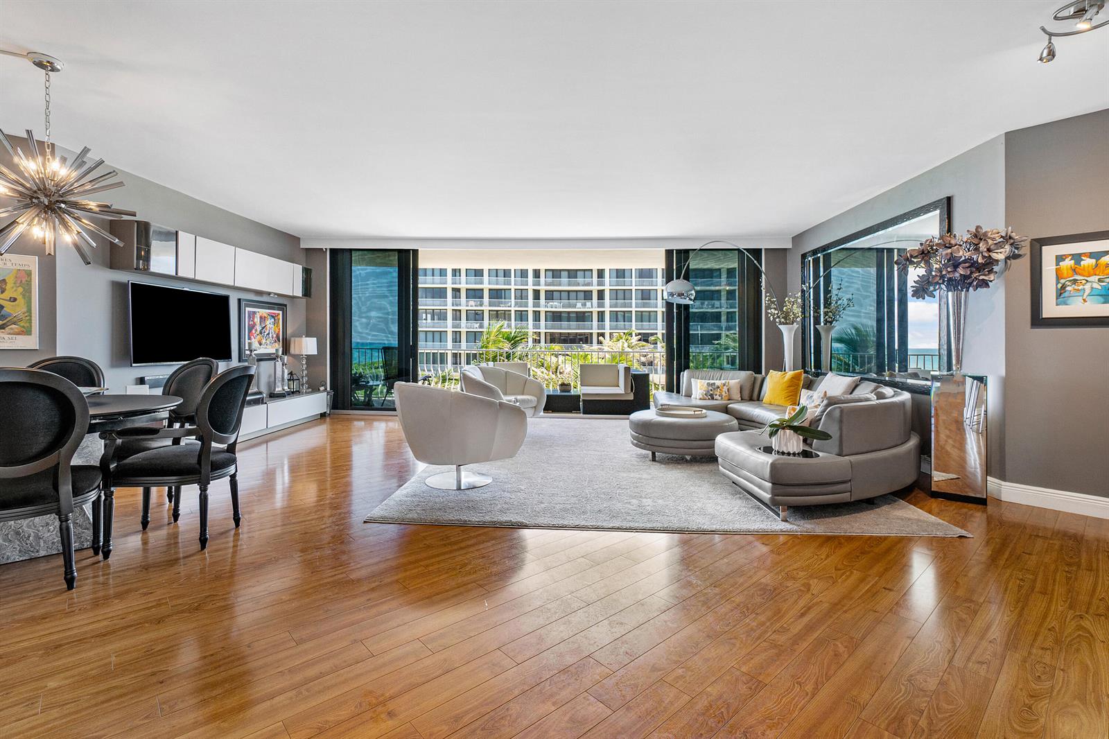 A modern living and dining area features hardwood floors, a gray sectional, and balcony views — 2000 S Ocean Boulevard # 208n, Palm Beach FL 33480, PALM BEACH, FL
