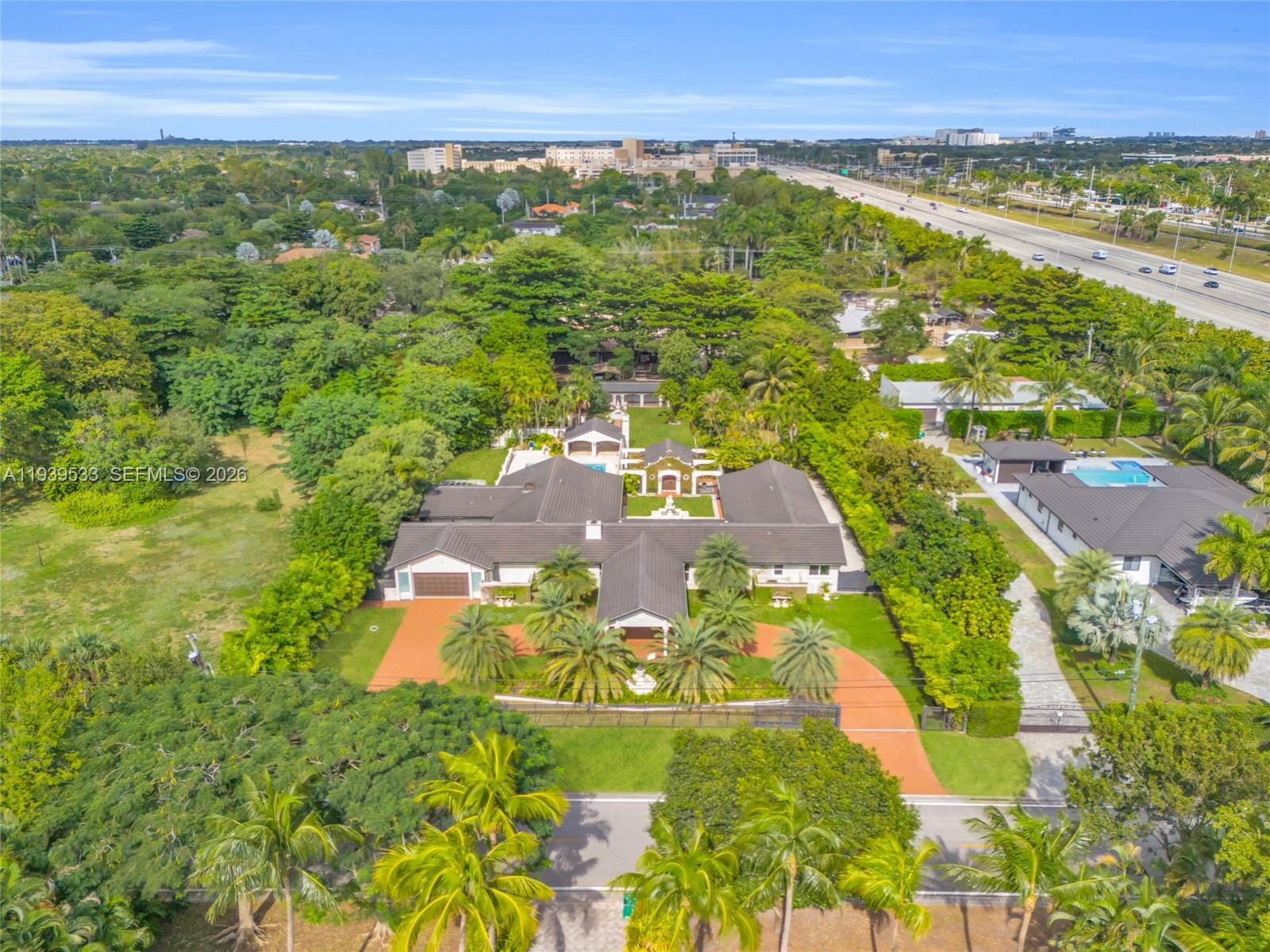 An aerial view shows a large house with a courtyard, pool, and circular driveway — 11835 SW 47th St, Miami FL 33175, MIAMI, FL