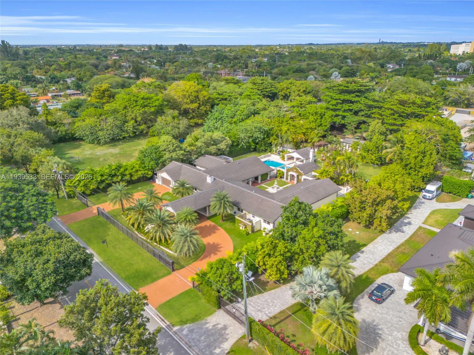 An aerial view shows a large house with a pool, courtyard, and circular driveway — 11835 SW 47th St, Miami FL 33175, MIAMI, FL
