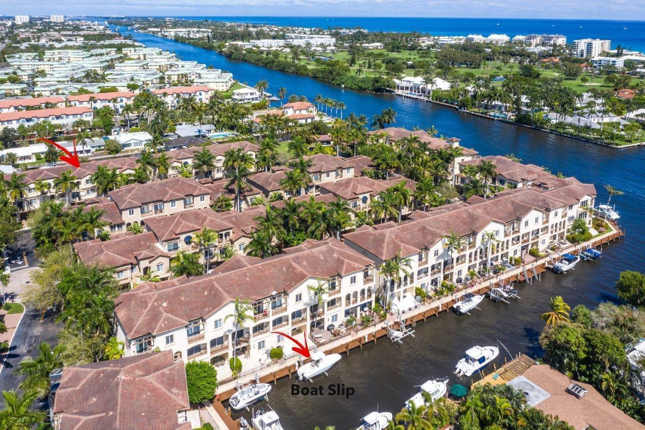An aerial view of a waterfront condominium complex featuring private boat slips along a canal — 3018 Waterside Circle, Boynton Beach FL 33435, BOYNTON BEACH, FL