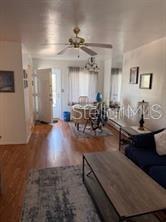 A living room with hardwood floors, a ceiling fan, and a dining area near the entrance — 5906 17TH STREET W UNIT C35, BRADENTON, FL