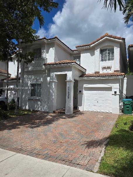 A two-story white stucco house features a brick driveway and a single-car garage — 11525 NW 71st St # 11525, Doral FL 33178, DORAL, FL