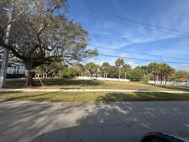 A large, grassy vacant lot features a prominent oak tree and several palm trees — 9506 SW 57th Ave, Pinecrest FL 33156, PINECREST, FL