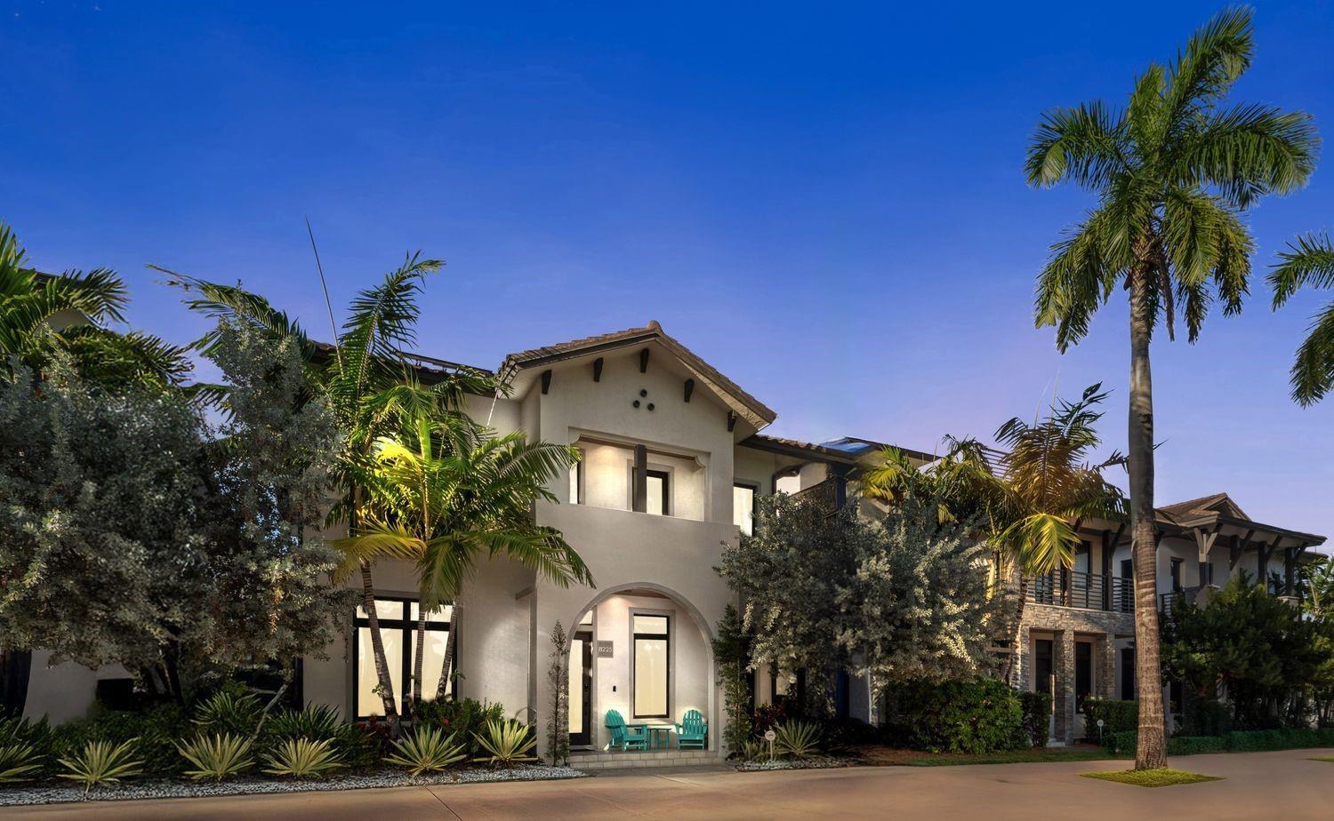 A two-story stucco home with a tiled roof, arched entryway, and surrounding palm trees — 8225 Central Park Boulevard, Doral FL 33166, DORAL, FL