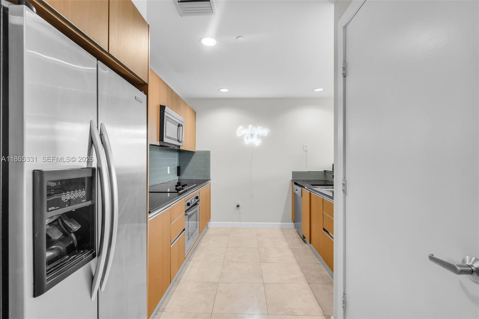 A bedroom features a bed, a bench, a bookshelf, and a large window with city views — 1060 Brickell Ave # 3601, Miami FL 33131, MIAMI, FL
