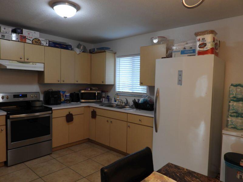 A kitchen with light wood cabinets, stainless steel appliances, and tile flooring — 2764 NW 1st Court, Pompano Beach FL 33069, POMPANO BEACH, FL