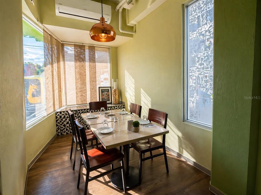 A dining area features a square table with four chairs, a pendant light, and windows — 619 CALLE CERRA, SAN JUAN, PR