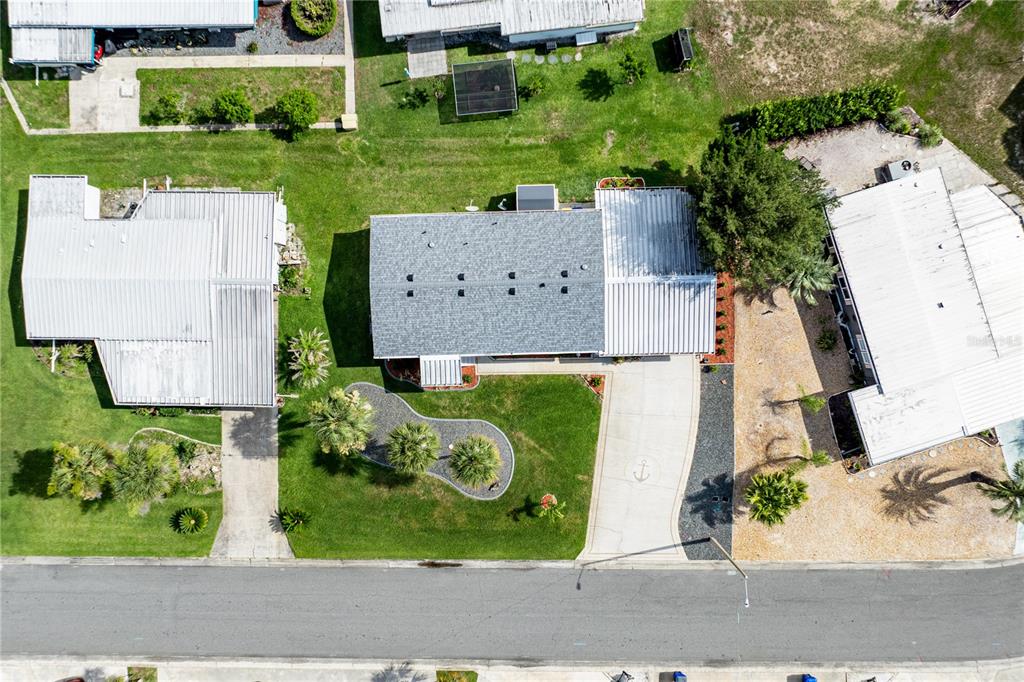 An aerial view shows a house with a gray roof, a driveway, and landscaped lawn — 2611 VINDALE ROAD, TAVARES, FL