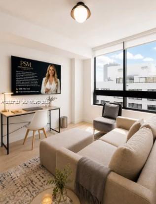 A modern living room features a desk, a sofa, and a large window with city views — 225 N Miami Ave # 3204, Miami FL 33128, MIAMI, FL