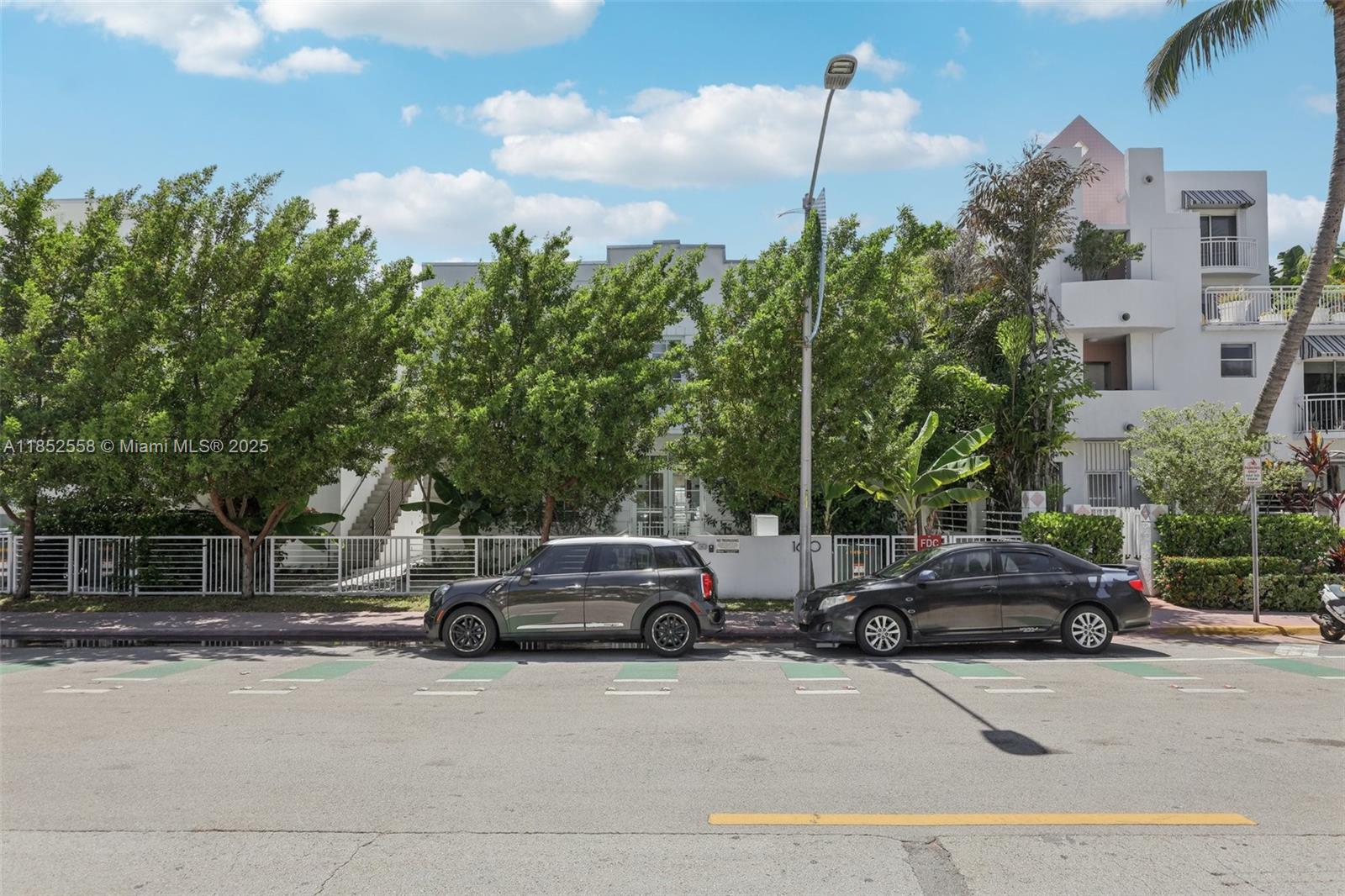A street view shows two parked cars in front of a white multi-story apartment building — 1610 Euclid Ave # B101, Miami Beach FL 33139, MIAMI BEACH, FL