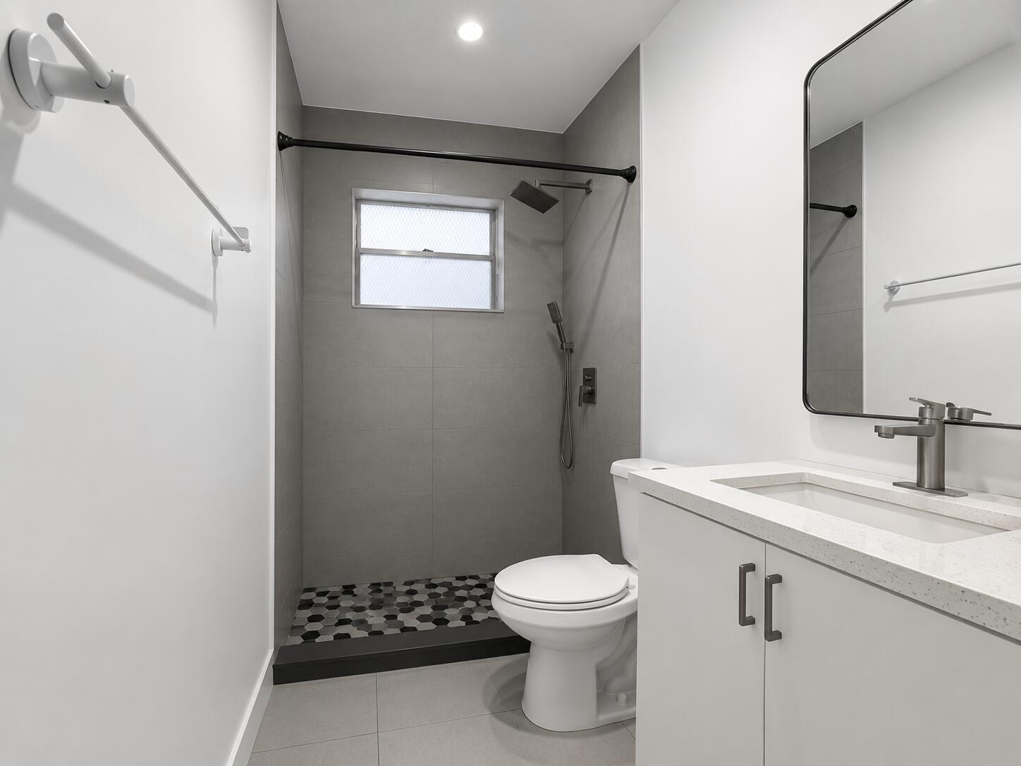 A modern bathroom features a walk-in shower with gray tile, a toilet, and white vanity — 2152 SW 72nd Avenue, Miami FL 33155, MIAMI, FL
