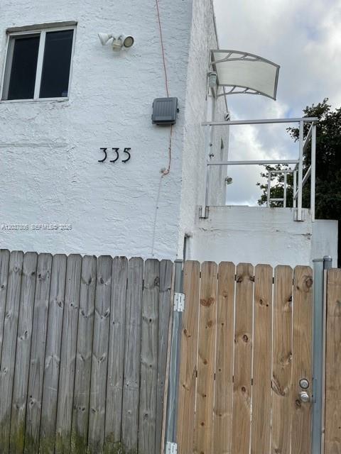 A white stucco building exterior features the number 335, a window, and a metal balcony — 337 NW 59th Ter # A, Miami FL 33127, MIAMI, FL