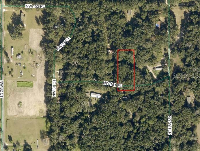 This is an aerial map showing a rectangular property lot outlined in red — 3069 NW 151ST PLACE, REDDICK, FL