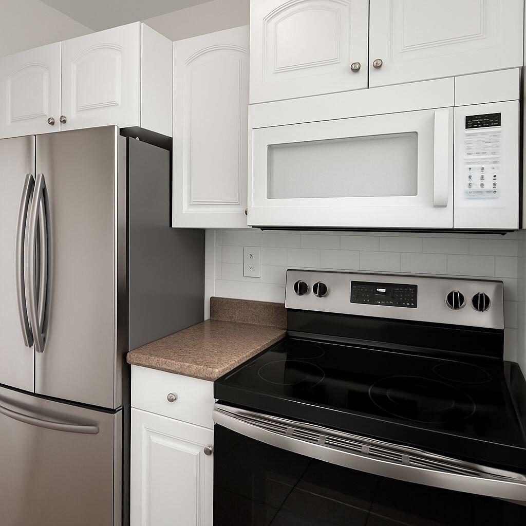 A kitchen features white cabinets, stainless steel appliances, and brown countertops — 3390 NE 16th Terrace # 5, Pompano Beach FL 33064, POMPANO BEACH, FL