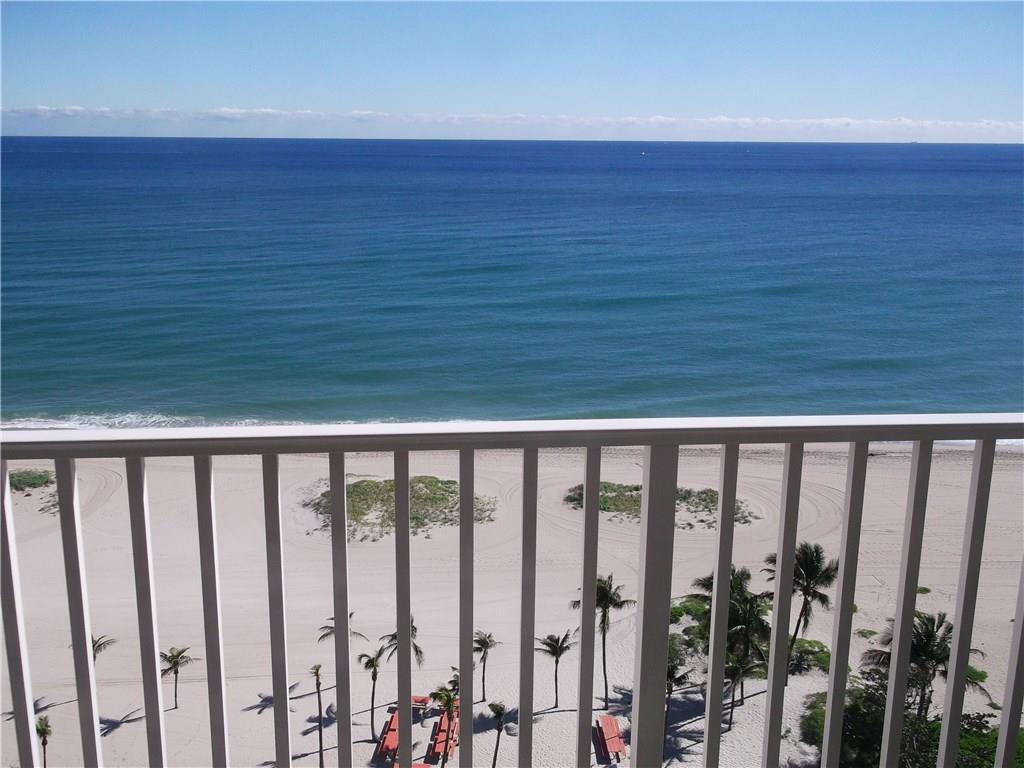 A balcony view overlooking a sandy beach, palm trees, and the blue ocean — 750 N Ocean Boulevard # 1709, Pompano Beach FL 33062, POMPANO BEACH, FL