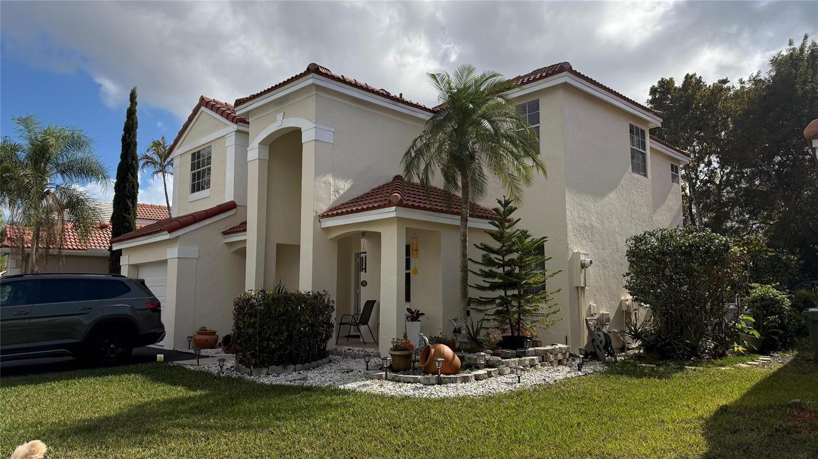 A two-story stucco house with a red tile roof, palm tree, and front driveway — 593 Bedford Avenue, Weston FL 33326, WESTON, FL