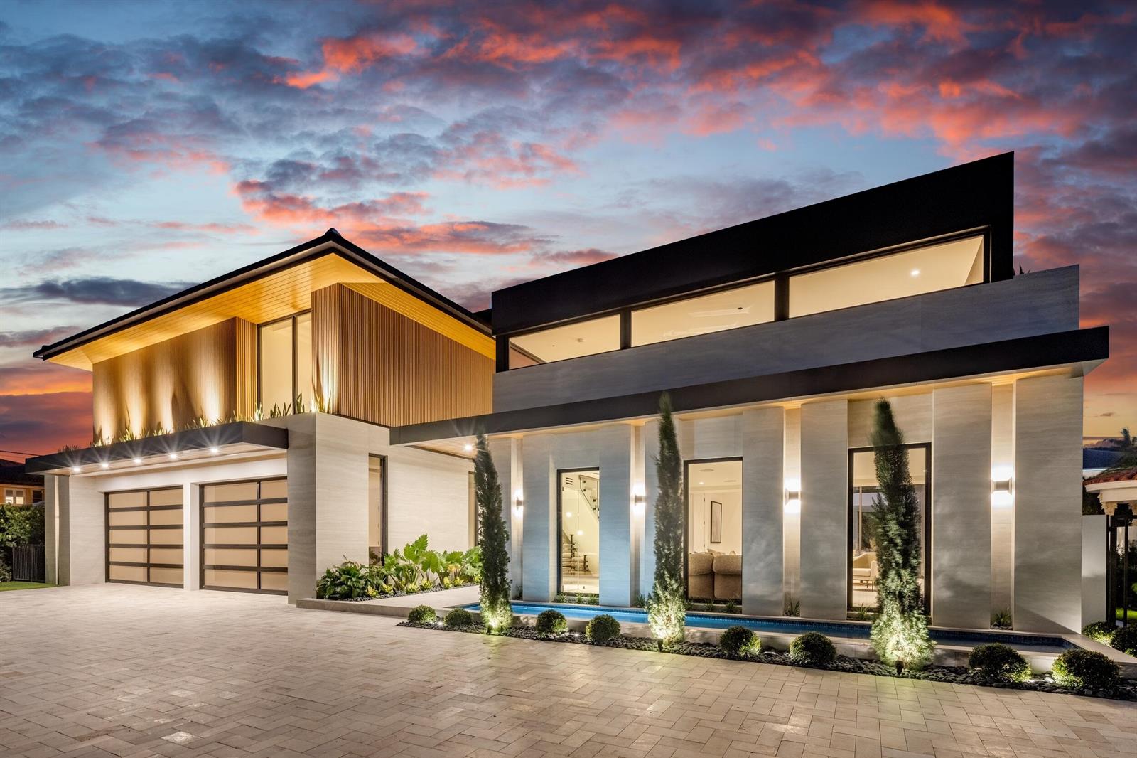 A modern two-story house exterior with a stone facade, garage, and a small reflecting pool — 1351 Cocoanut Road, Boca Raton FL 33432, BOCA RATON, FL