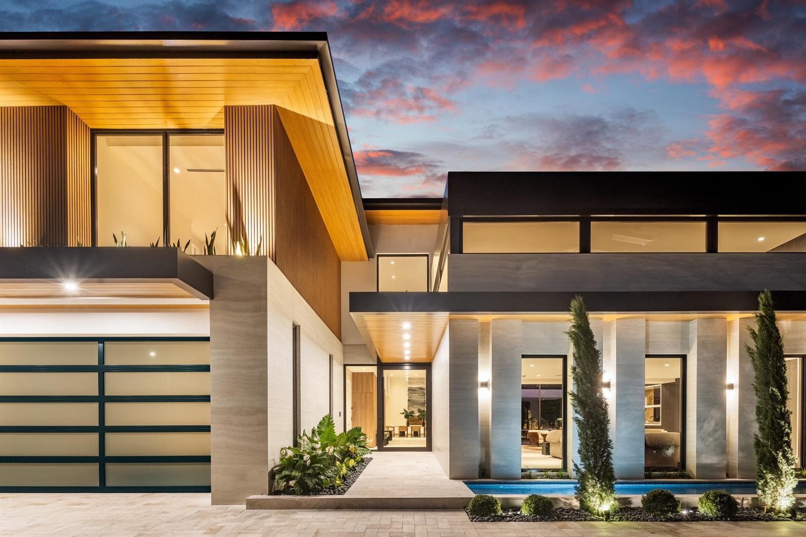A modern two-story house exterior features a garage, stone facade, and a front entry pool — 1351 Cocoanut Road, Boca Raton FL 33432, BOCA RATON, FL