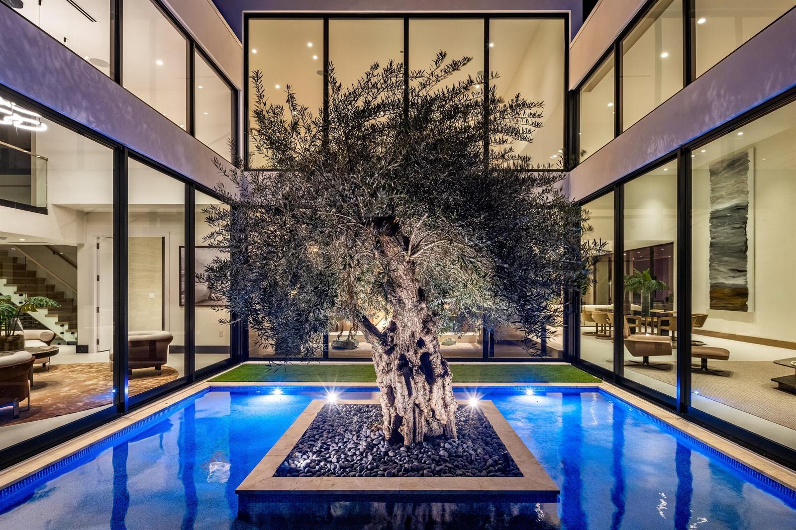 A central olive tree sits in a stone planter within a pool inside a courtyard — 1351 Cocoanut Road, Boca Raton FL 33432, BOCA RATON, FL