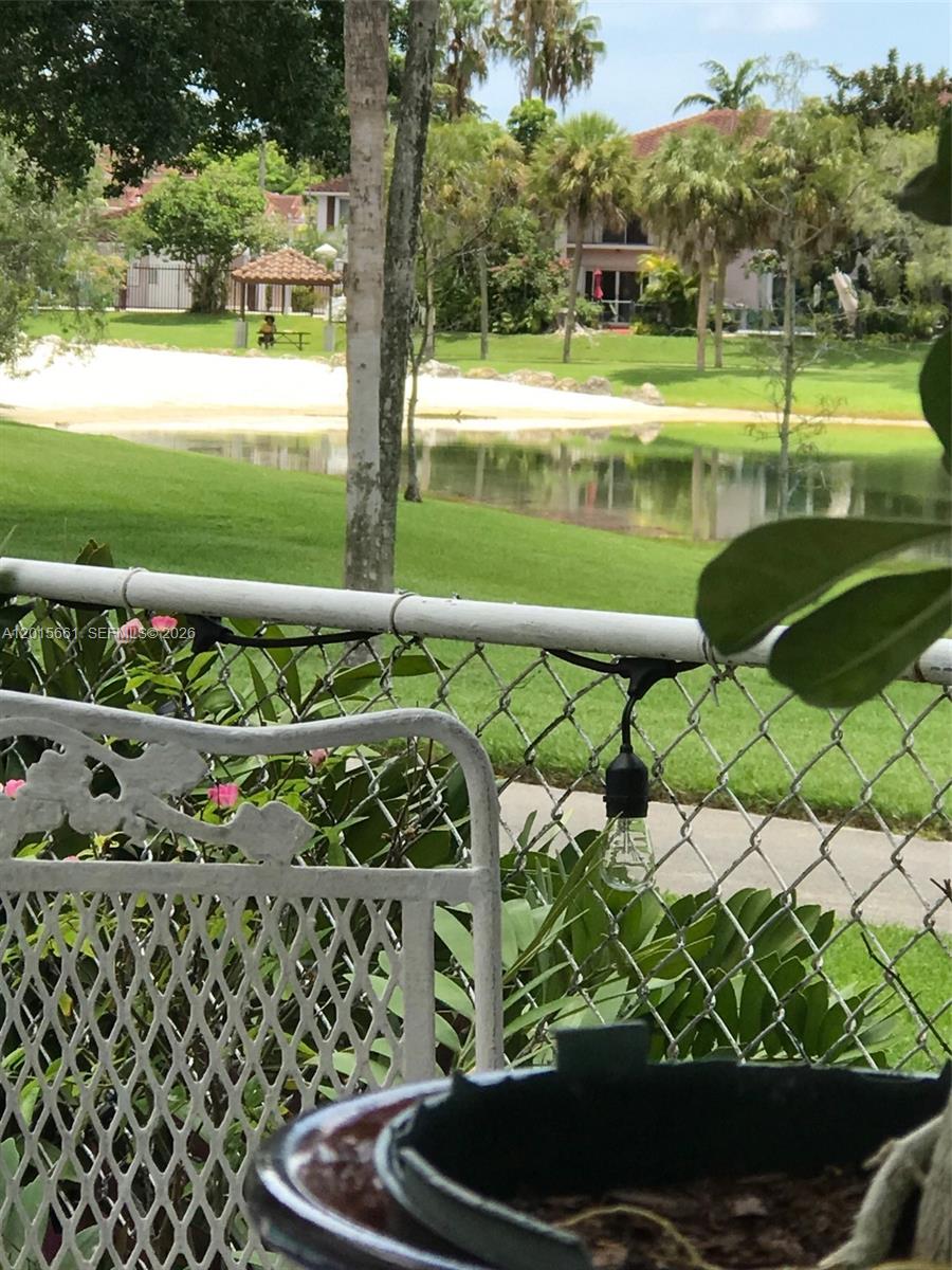 A view of a grassy yard, a small pond, and a gazebo from a patio — 10135 SW 156th Ave, Miami FL 33196, MIAMI, FL