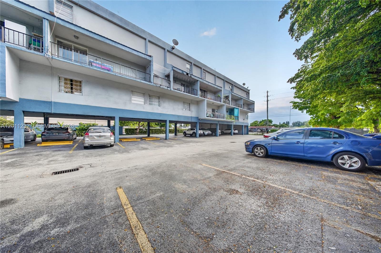 A multi-story apartment building with covered ground-level parking and balconies — 399 NW 72nd Ave # 209, Miami FL 33126, MIAMI, FL