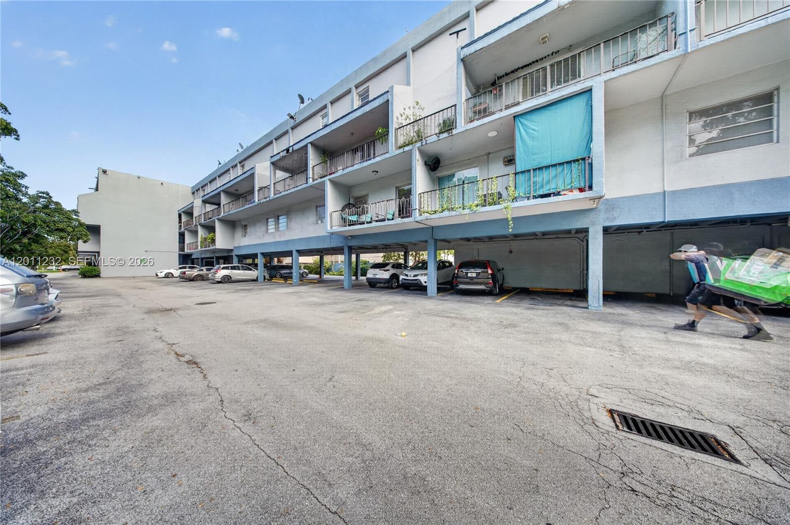 A multi-story apartment building with covered ground-level parking and balconies — 399 NW 72nd Ave # 209, Miami FL 33126, MIAMI, FL