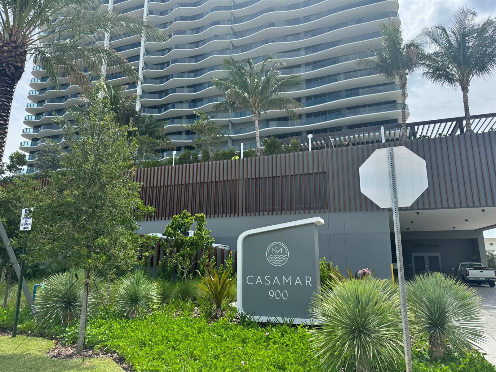 A modern residential building with wavy balconies stands behind a Casamar 900 entrance sign — 900 N Ocean Boulevard, Pompano Beach FL 33062, POMPANO BEACH, FL