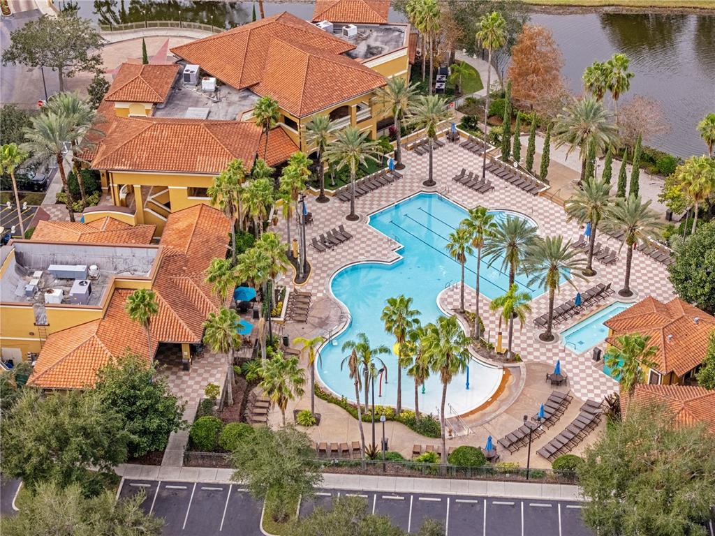 An aerial view shows a large clubhouse with a tiled roof and a swimming pool — 12544 FLORIDAYS RESORT DRIVE, ORLANDO, FL