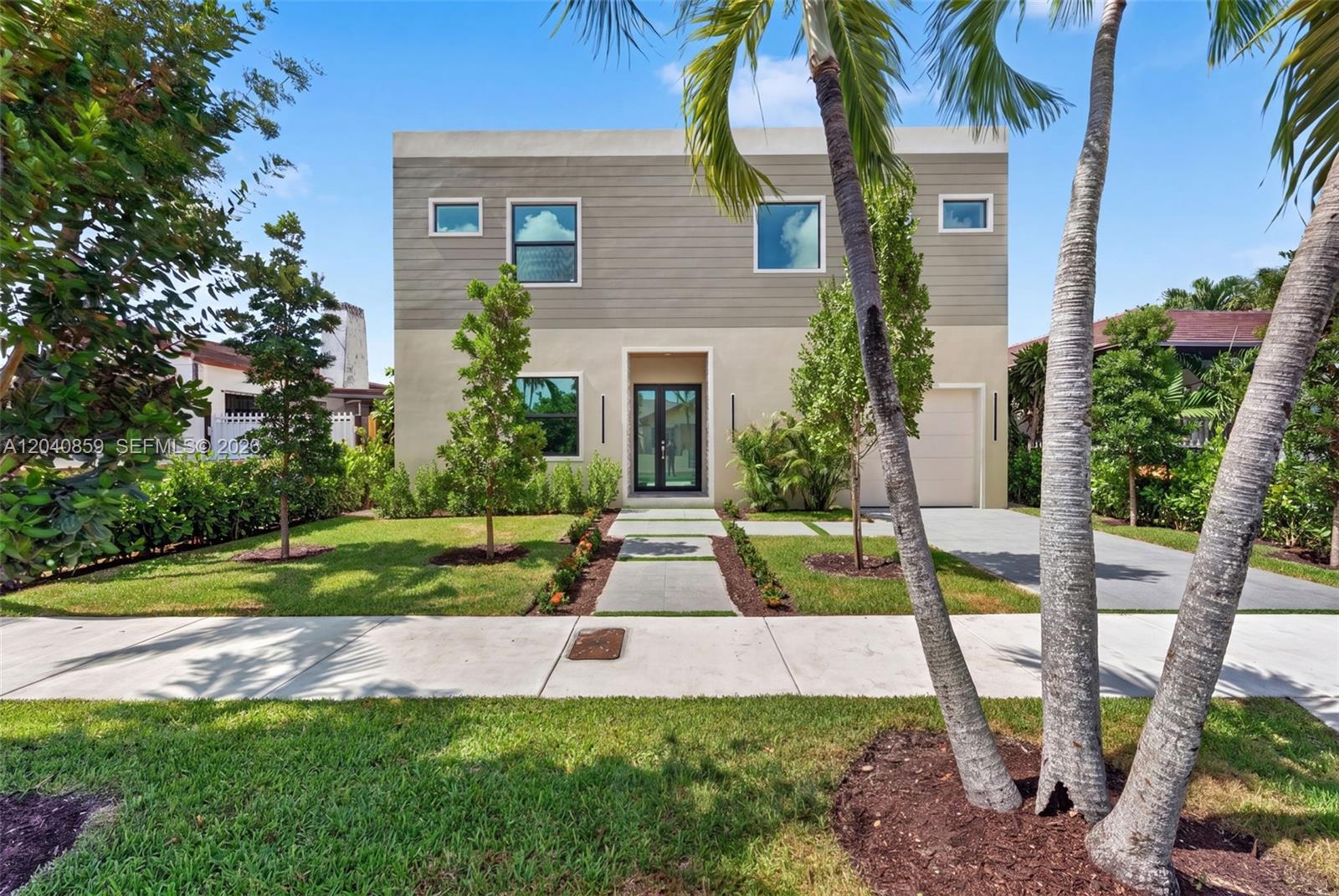 A modern two-story house features a flat roof, horizontal siding, and a paved walkway — 2240 SW 13th St, Miami FL 33145, MIAMI, FL