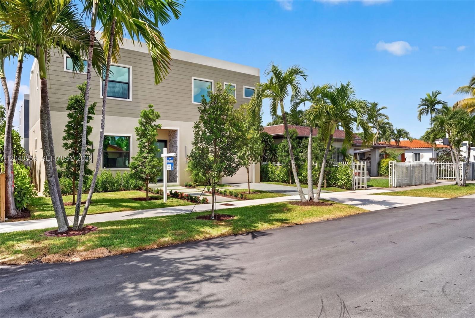 A modern two-story house with a beige exterior and palm trees in the front yard — 2240 SW 13th St, Miami FL 33145, MIAMI, FL