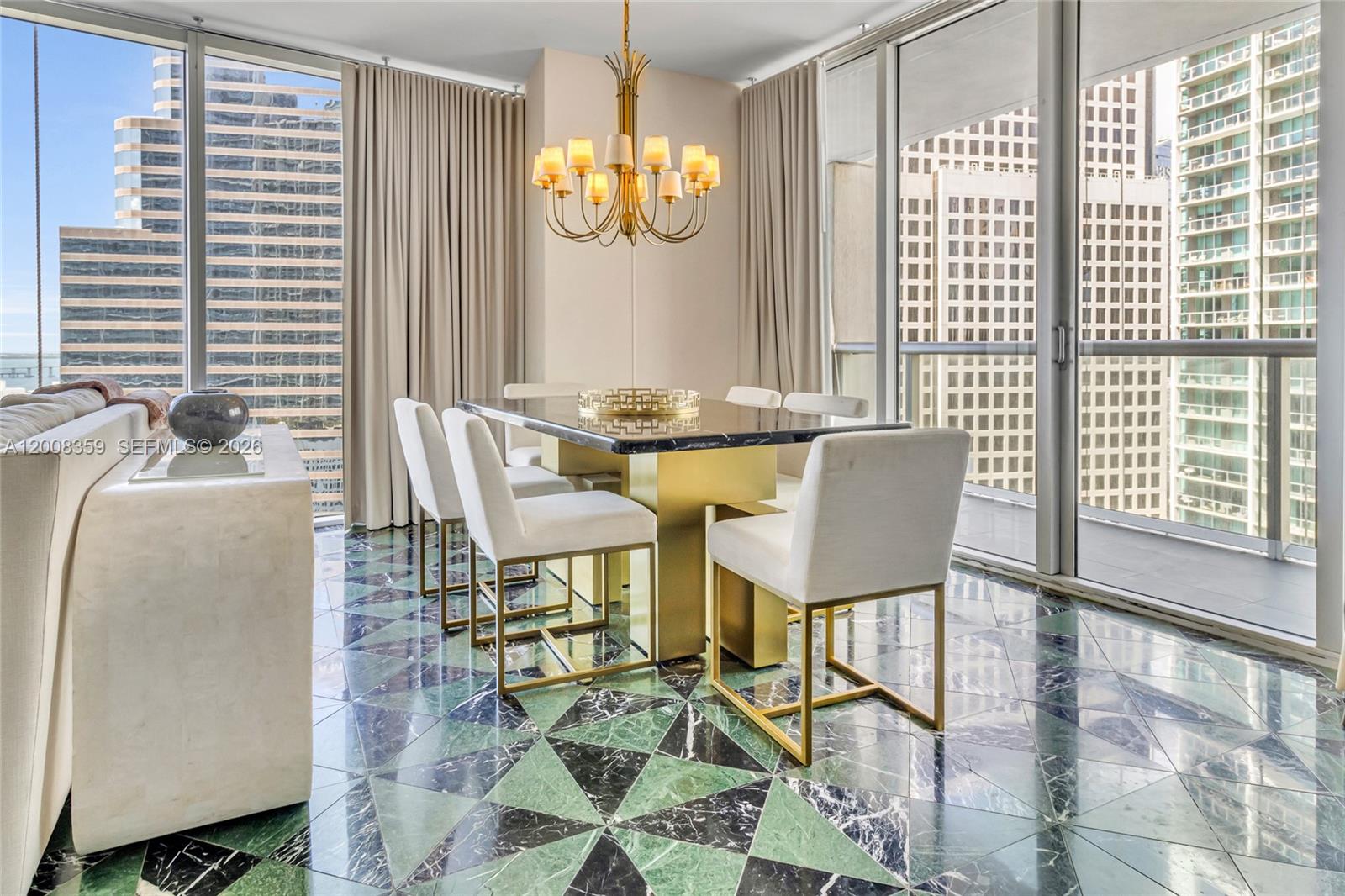 A dining room features a marble table, gold chairs, and geometric green marble flooring — 485 Brickell Ave # 2508, Miami FL 33131, MIAMI, FL
