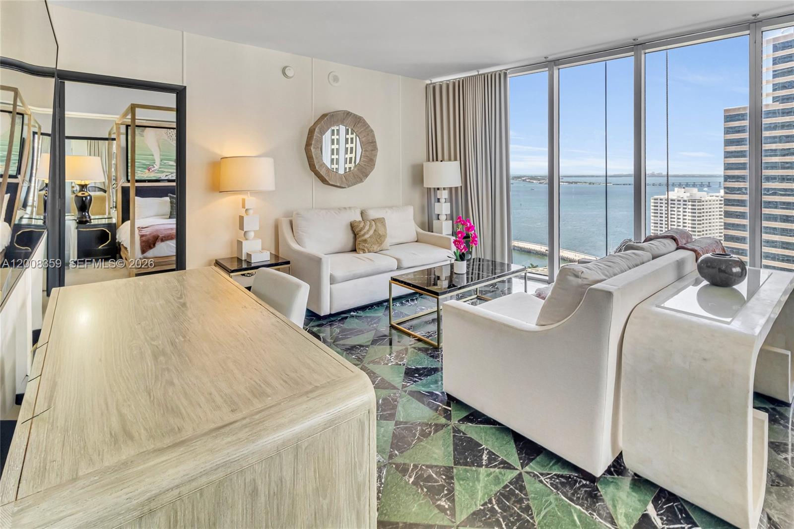 A living room features a green and black geometric marble floor, white sofas, and floor-to-ceiling windows — 485 Brickell Ave # 2508, Miami FL 33131, MIAMI, FL