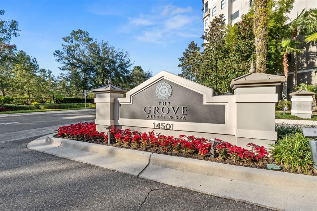 A stone monument sign for The Grove Resort & Spa sits in a landscaped garden — 14501 GROVE RESORT AVENUE UNIT 2607, WINTER GARDEN, FL