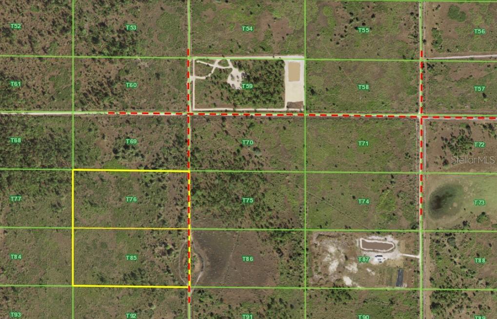 This is an aerial map showing a highlighted rectangular land parcel divided into grid sections — 50530 BERMONT ROAD, PUNTA GORDA, FL