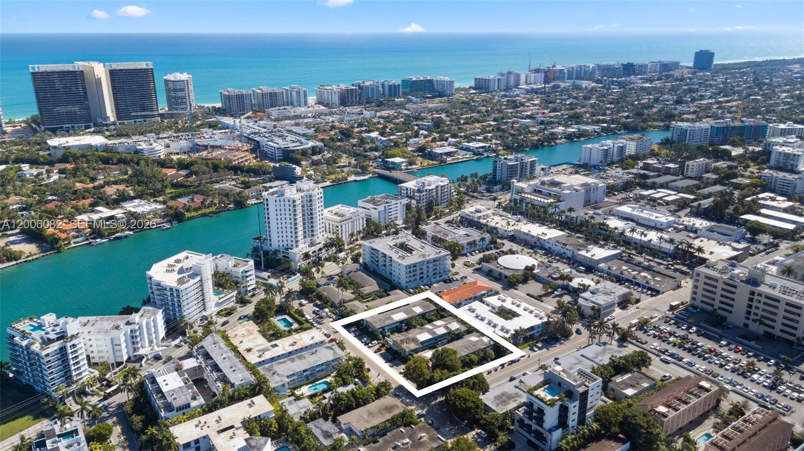 An aerial view shows a low-rise apartment complex outlined in white within a coastal city — 1060 98 St, Bay Harbor Islands FL 33154, BAY HARBOR ISLANDS, FL