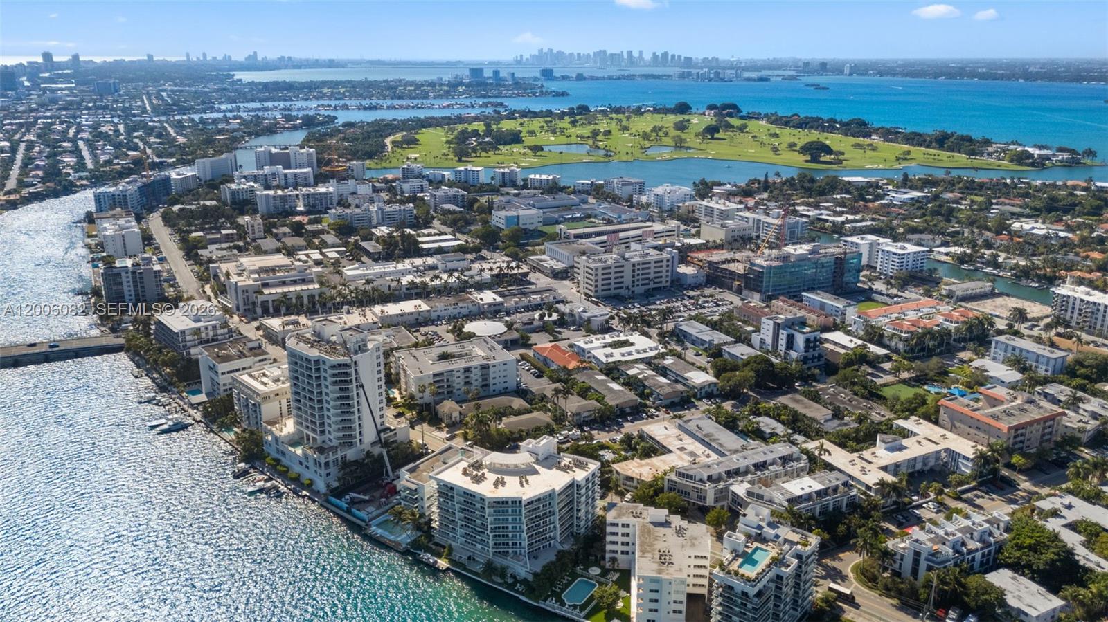 An aerial view shows a coastal neighborhood with apartment buildings, a golf course, and water — 1060 98 St, Bay Harbor Islands FL 33154, BAY HARBOR ISLANDS, FL