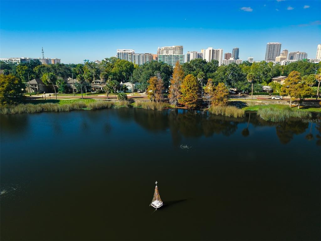 An aerial view of a lake with a floating Christmas tree and city skyline background — 109 S BROWN AVENUE, ORLANDO, FL