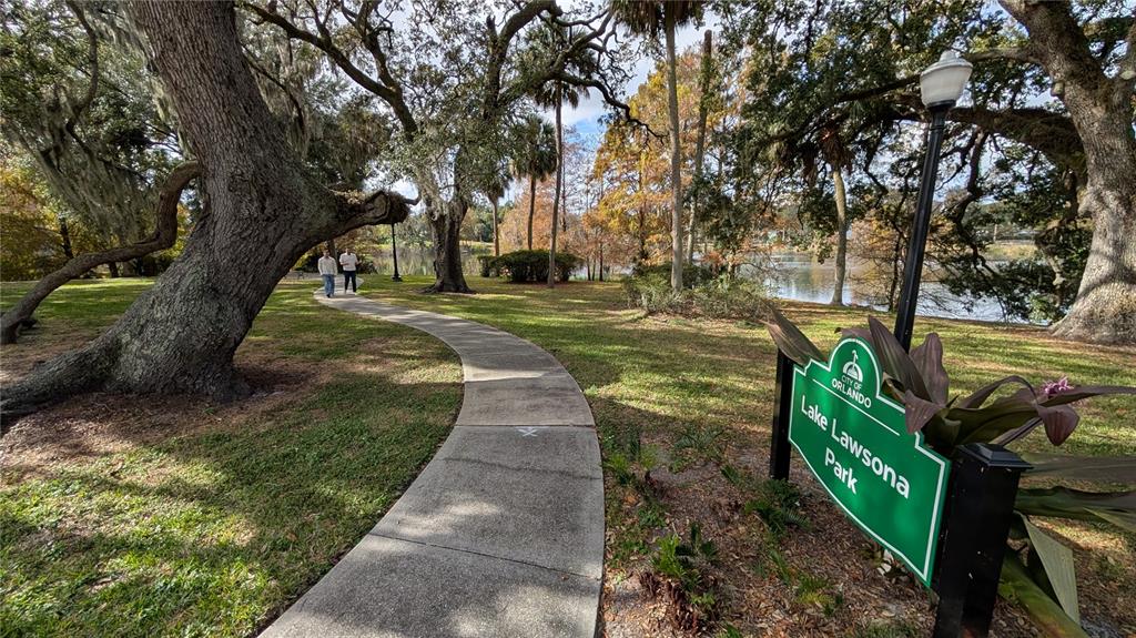 A paved path winds through a park with large oak trees beside a lake — 109 S BROWN AVENUE, ORLANDO, FL