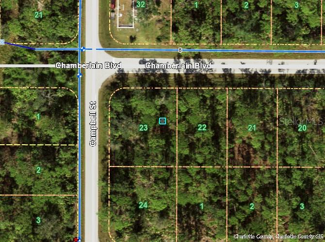 This is an aerial map showing a vacant lot highlighted near the intersection of two roads — 12023 CHAMBERLAIN BOULEVARD, PORT CHARLOTTE, FL