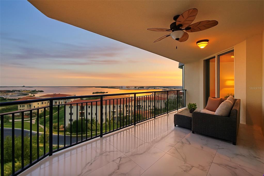 A balcony with marble-look tile flooring, a ceiling fan, and a view of the water — 5823 BOWEN DANIEL DRIVE UNIT 902, TAMPA, FL